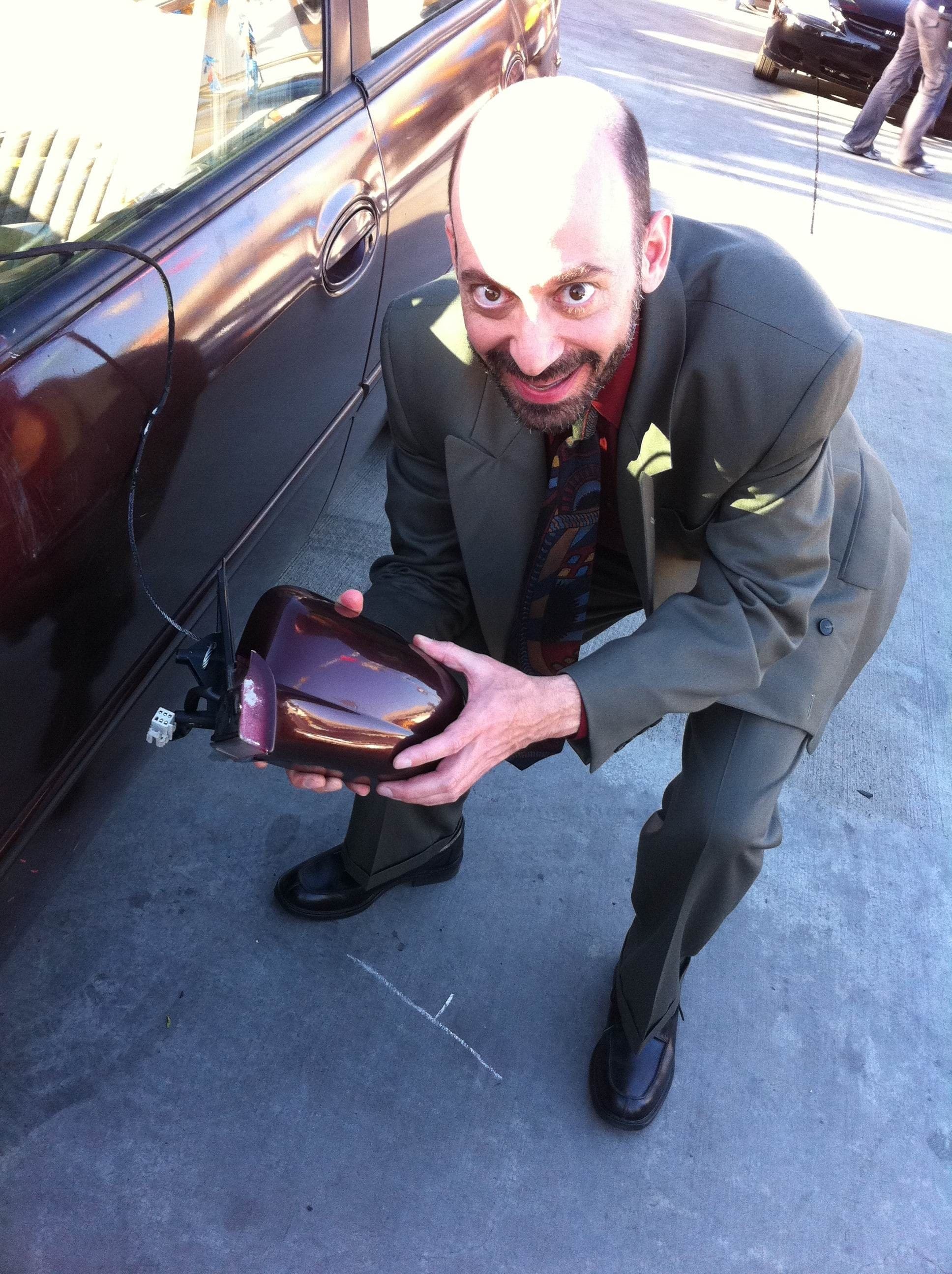 Actor Jeff Blumberg on set shooting a TV commercial, playing the role of a used car salesman